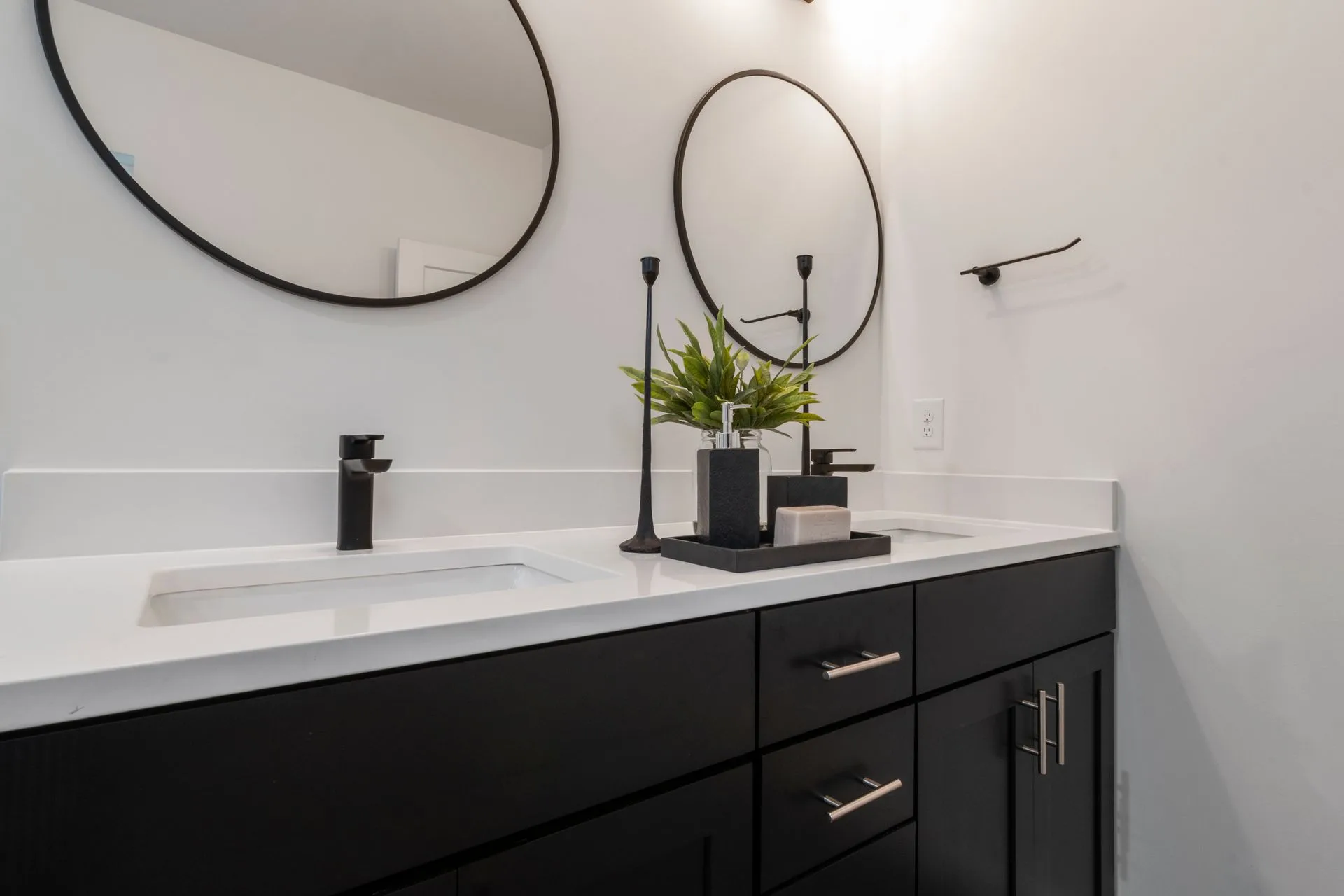 Black and white double-sink vanity with round mirrors