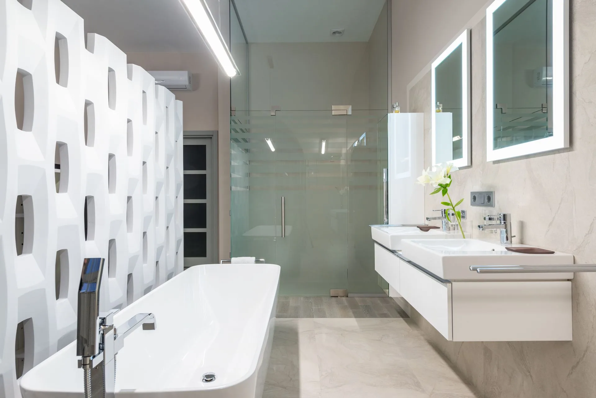 Bathroom with glass partition and sleek tub