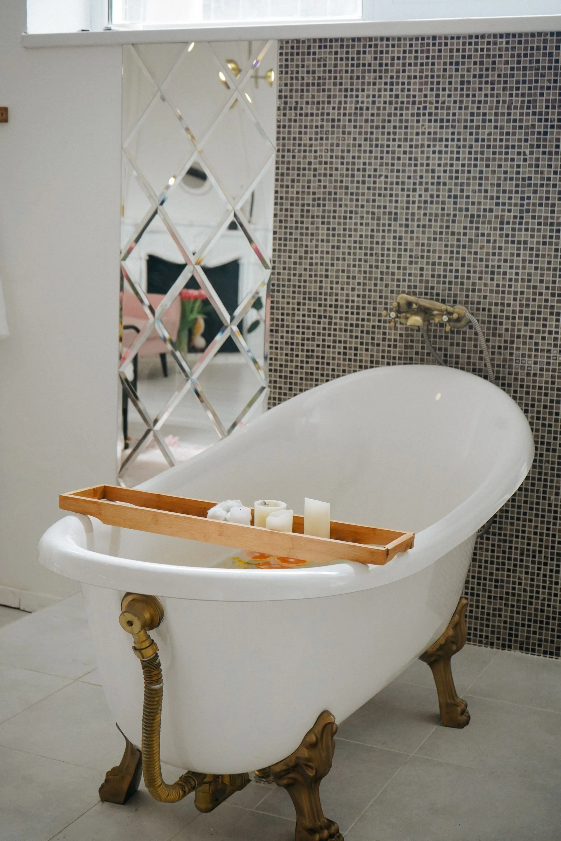 Freestanding bathtub with mosaic accent wall