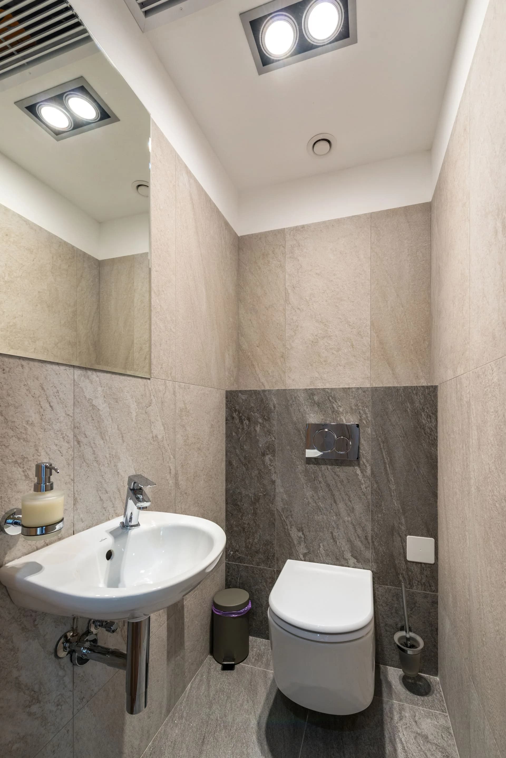 Minimalist bathroom with ceramic sink and toilet